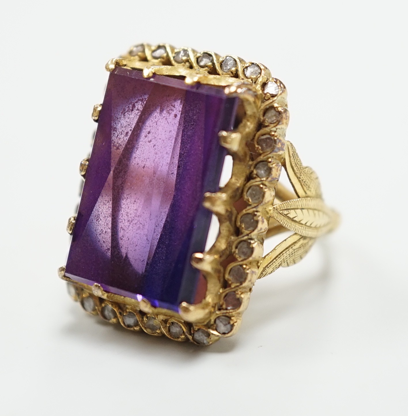 A Portuguese? yellow metal (stamped 800) and rectangular cut synthetic colour change corundum set dress ring, with diamond chip set border, size M, gross weight 13 grams.